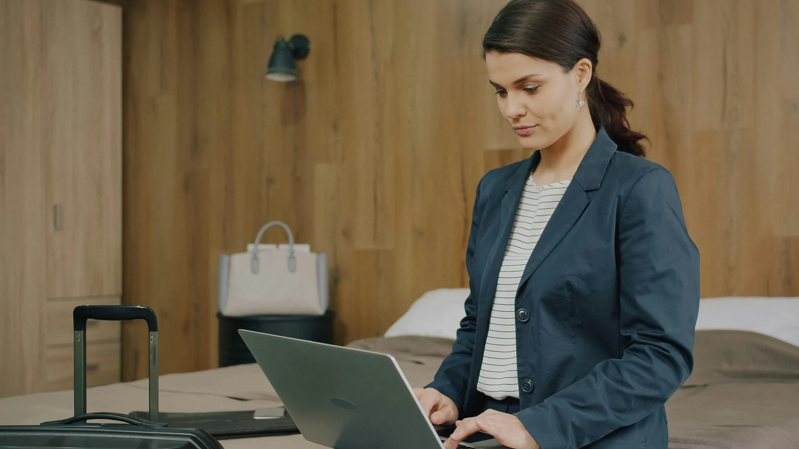 Business traveller working on a laptop in a hotel room.